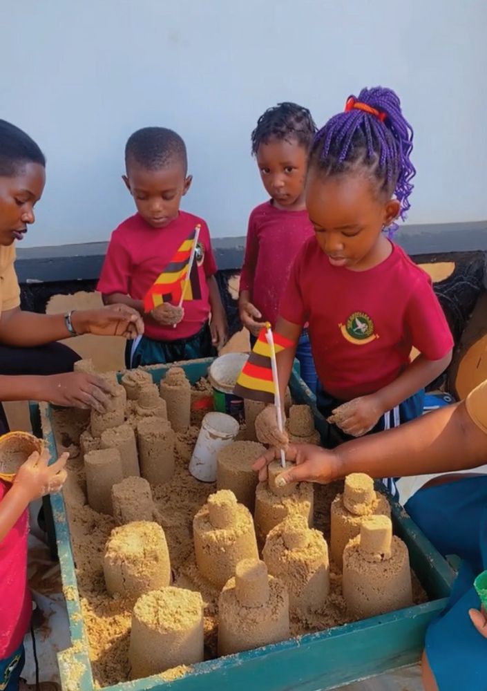 Children building sandcastles together