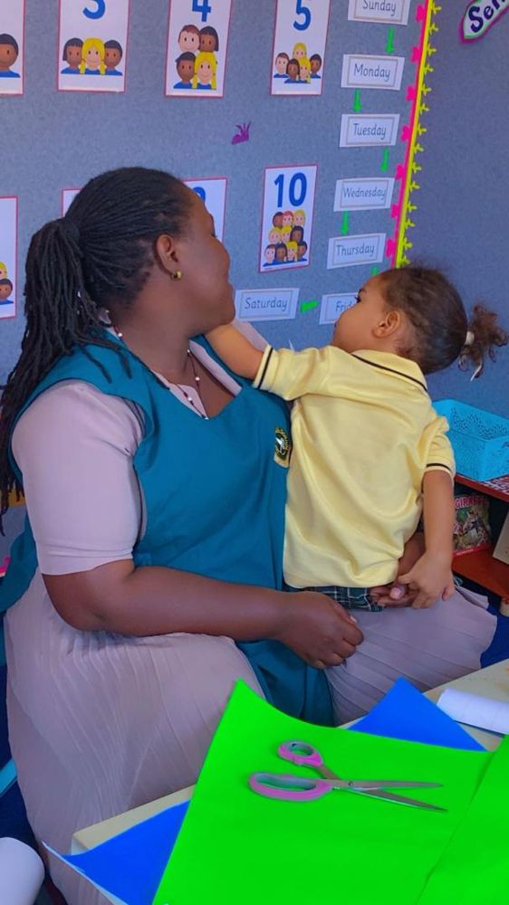 A teacher sharing a warm moment with a pupil